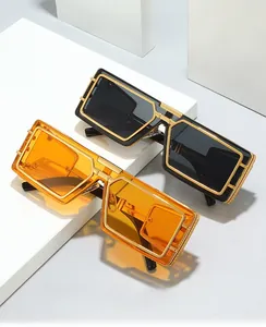 Detail of geometric metal sunglasses frames with black and orange transparent lenses