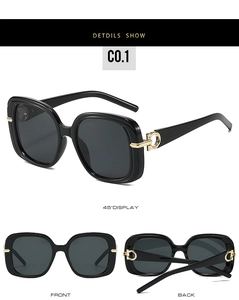Detail view of black square oversized sunglasses with gold metal hinge and grey lenses