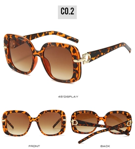 Detail of square oversized tortoise sunglasses with gradient lenses and gold metal accents