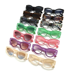 Collection of retro cat-eye sunglasses and frames in various colors on white background