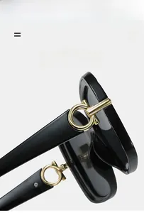 Detailed close-up of square sunglasses featuring golden metal accents on the temple hinges