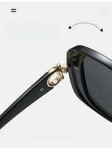 Macro shot of durable square frame sunglasses showing the reinforced golden metal hinge