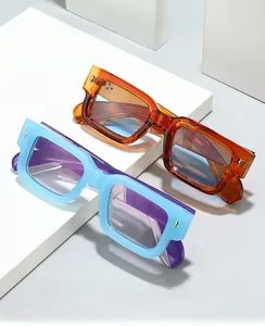 Close-up of retro square sunglasses with amber and blue frames and gold diamond accents