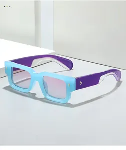 Detail of square sunglasses with light blue frames and purple gradient lenses