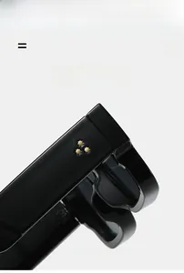Detail of square sunglasses featuring three gold star rivets on black glossy temples