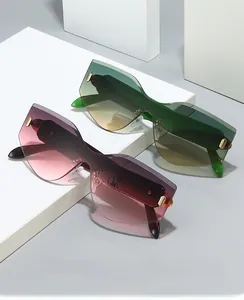 Detail of rimless oversized sunglasses with colorful gradient lenses and gold accents