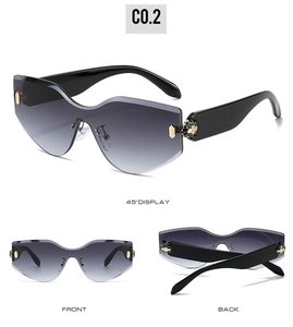 Detail of rimless wave lenses and decorative gold snake head hinge on stylish sunglasses