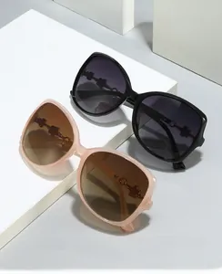 Detail of oversized sunglasses with metallic flower hinge on modern geometric blocks
