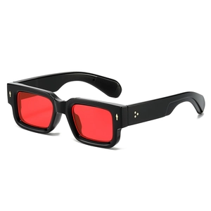 Fashionable square frame sunglasses with black glossy frame and red lenses on white background