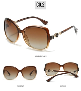 Three-angle view of oversized sunglasses with brown gradient lenses and gold flower detail