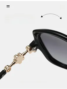 Macro shot of durable golden hinge on black oversized sunglasses with petal detail