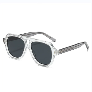 Modern transparent aviator sunglasses with polarized dark lenses and gold rivet accents