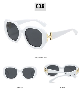 Detail view of square sunglasses featuring white frames and gold H-shaped metal hinges