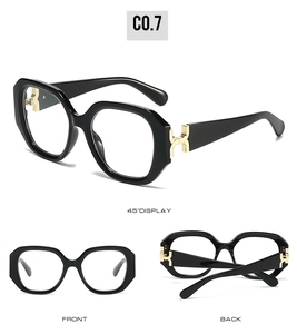 Macro detail of square black sunglasses with luxury gold metal hinges and H-shape accents