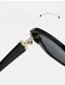 Detail of durable gold metal hinges on square black sunglasses with screw fixation