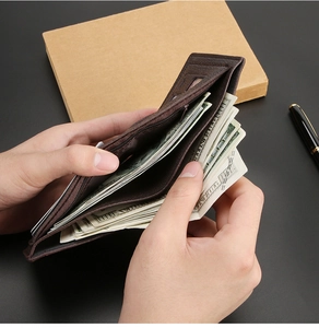 Detailed view of brown leather wallet with multiple bill slots and secure zipper pocket