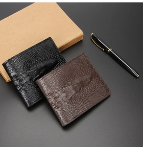 Macro shot of faux crocodile leather men's wallet with 3D embossed alligator head texture
