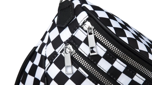 Close-up of dual silver metal zippers on waterproof nylon crossbody bag with diamond pattern