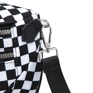 Detail of silver dual metal zippers and detachable strap on black and white checkered bag