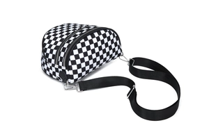 Detail of checkered crossbody bag showing double zipper closure and nylon fabric