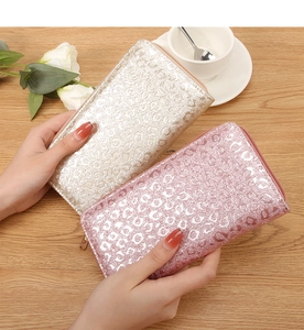 Detail of glitter leopard print long wallets in champagne gold and bright pink finishes