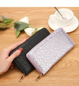 Detailed view of long zip wallets in black and silver purple with leopard texture