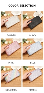 Multiple color selection for long leopard embossed zip wallets on a wooden surface