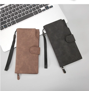 Detail of matte synthetic leather long wallets in coffee and grey with wrist straps