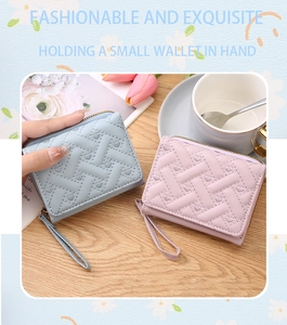 Mini pastel quilted coin purses with heart patterns on a wooden table setup