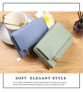 Detailed close-up of soft lychee textured leather wallets with golden zippers on wood background
