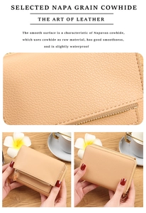 Close-up of beige napa grain cowhide texture and gold zipper detail on small wallet