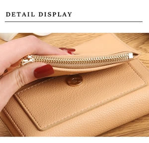 Close-up of light brown litchi pattern leather wallet with gold zipper and stitching detail