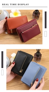 Litchi pattern leather coin purses in four colors with gold zipper on wooden table