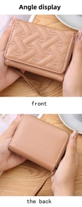 Detail view of quilted PU leather mini wallet with heart embroidery and wrist strap