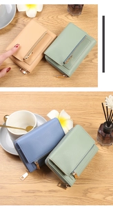 Litchi texture leather wallets in mint and blue on a warm wooden tabletop setting