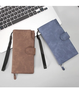 Detail view of brown and blue vintage nubuck texture wallets with wrist straps and snap buttons