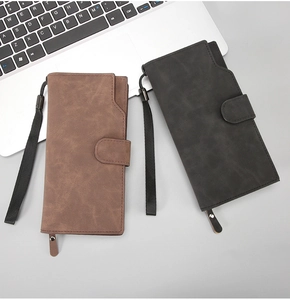 Long leather textured wallet detail with side wrist strap and zipper pocket