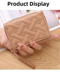Detail of mini faux leather coin purse with heart embroidery and cross-quilted pattern
