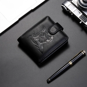 Business bifold wallet with bull head embossing and snap closure on dark desk