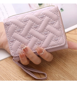 Detail of lavender woven texture with heart embroidery on mini wallet with gold zipper