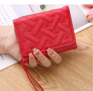 Close-up of red PU leather mini wallet featuring heart embroidery and gold zipper detail