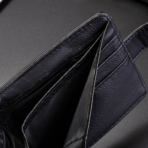 Internal detail of black lychee leather wallet featuring card slots and zipper pocket