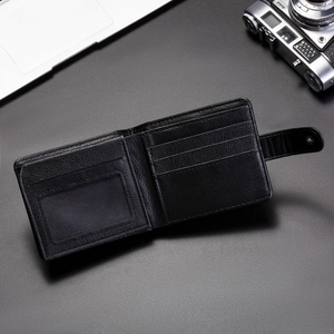 Detail of black pebbled leather wallet with multiple card slots and snap button closure