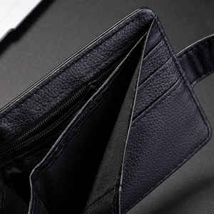 Detail of premium black lychee leather wallet with card slots and metal zipper compartment