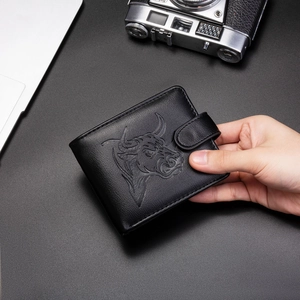Detail of black leather men's wallet with bull head embossing and snap button closure