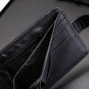 Detailed macro view of litchi texture black leather wallet interior with card slots