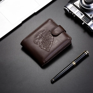 Detailed view of the embossed eagle pattern and textured leather on the brown men's wallet