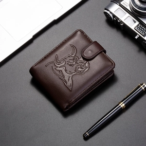 Macro detail of brown leather wallet featuring embossed bull head and snap button closure