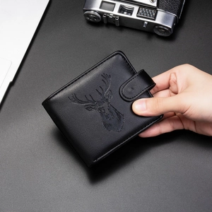 Detail of bifold men's wallet with embossed stag logo on premium black faux leather