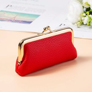 Detail of red lychee grain leather mini purse with vintage gold frame and bead clasp